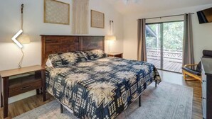 A bedroom with a large bed, a desk, a chair, and a ceiling fan. - Modern Mountain Cabin Close to Skiing w/firepit (Newland)