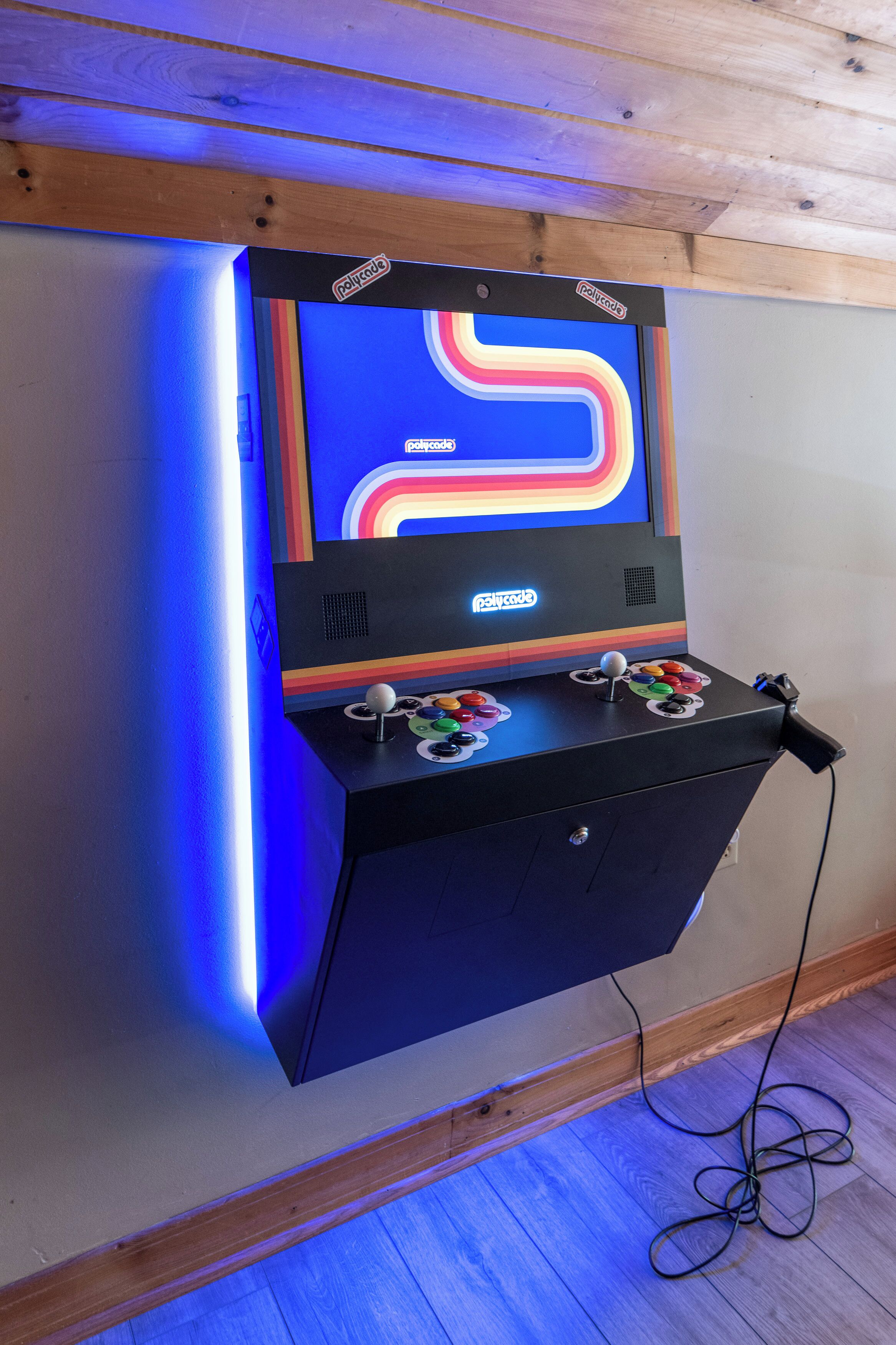 A retro arcade machine with colorful graphics and two joystick controllers.
