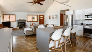 A modern kitchen with white cabinets, a stainless steel refrigerator, and a built-in oven. - Reservoir Retreat with Hot Tub and Mtn. Views! (Fort Collins)