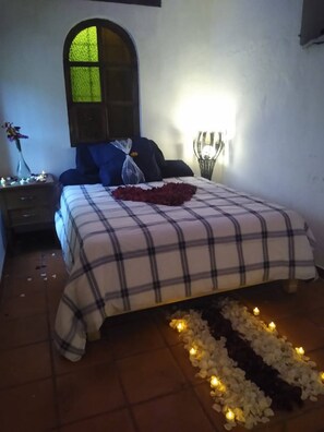 Cozy retreat with a large bed, bedside table, and soft lighting.