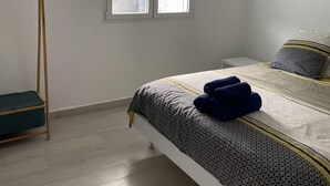 A bedroom with a bed, a window, and a ceiling fan. - Villa Rubis equipped for people with reduced mobility  (Gourbeyre)