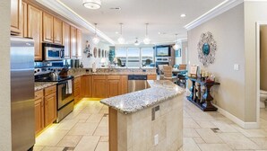 A spacious kitchen with granite countertops, stainless steel appliances, wooden cabinets, and a large island. - GWEN'S GETAWAY!!, TOP FLOOR! 10 Mile View, Kid Friendly! (Osage Beach)