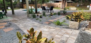A patio with a pool, outdoor furniture, and various plants. - Ponte Vedra Wilderness Oasis minutes from TPC and the beach (Ponte Vedra Beach)