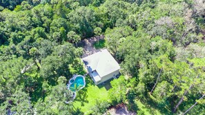 An aerial view of a house surrounded by dense forest, with a swimming pool and a well-maintained lawn. - Ponte Vedra Wilderness Oasis minutes from TPC and the beach (Ponte Vedra Beach)