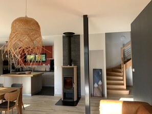 A modern interior with a kitchen, dining area, and a staircase. - Quiet mountain house, ideal for hiking, skiing, cycling - village within walking distance (Arcizans-Avant)