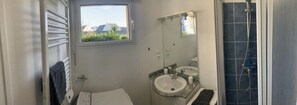 Shower, hair dryer, towels, toilet paper