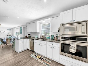 Enjoy cooking in this well-equipped kitchen with a dishwasher, double oven, and microwave.