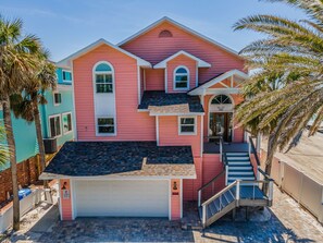 A two-story house with a garage, a staircase, and a front porch.