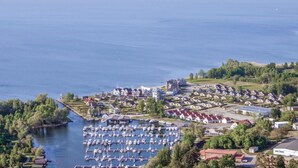 An aerial view of a coastal residential area with a marina filled with boats. - Nice home in Rechlin with sauna (Rechlin)