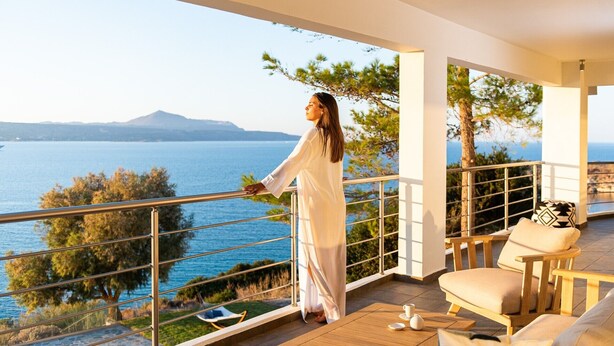 A balcony with a view of the sea, a wooden table, and two chairs. - KEA, above the sea, superb views, near beach. (Almyrida)