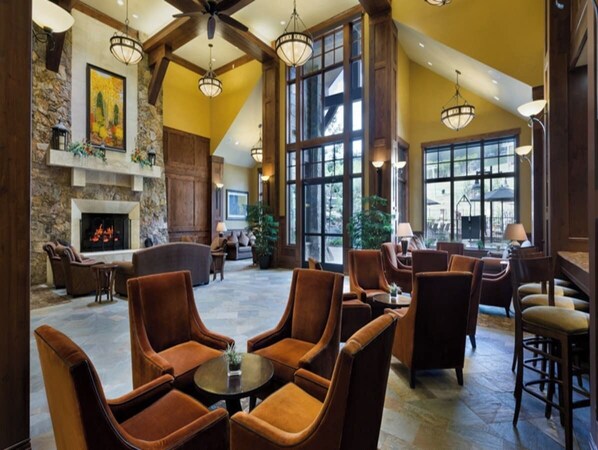Relax in a spacious lobby with plush seating areas, a fireplace, and large windows.