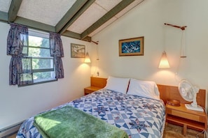 A bedroom with a bed, two bedside tables, a window with curtains, and two wall-mounted lamps. -  Gone Fishing!  Is Pet Friendly! (South Hero)