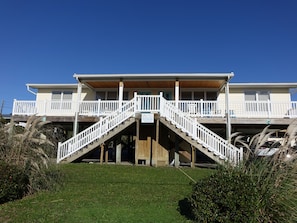 Un bâtiment à deux étages avec un escalier en bois menant à un balcon.