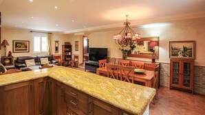 A spacious living area with a kitchen island, dining table, and seating. - Beautiful home in Orihuela (Orihuela)