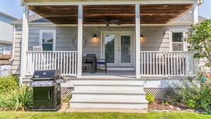 A two-story house with a covered porch, a grill, and a door with glass panels. - Beach House w/ a VIEW! Walk to Beach and Newport (Middletown)