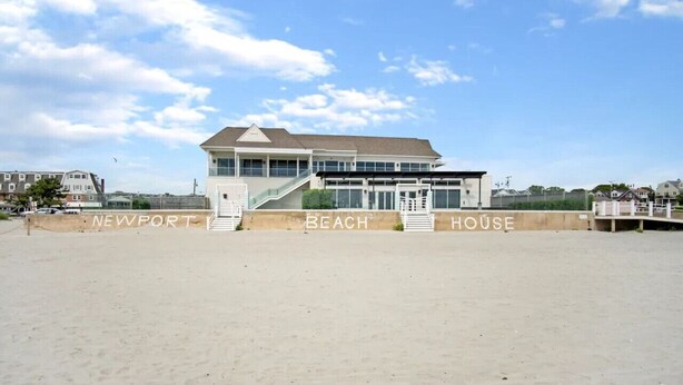 A beachfront hotel with a modern design, featuring a prominent staircase leading to the entrance. - Beach House w/ a VIEW! Walk to Beach and Newport (Middletown)