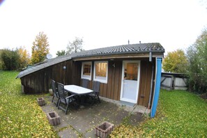 Guests can enjoy a quiet retreat with a door, window, and small porch area.