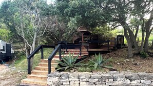 A wooden staircase leading to a gazebo in a wooded area. - Casita in the Oaks (Canyon Lake)
