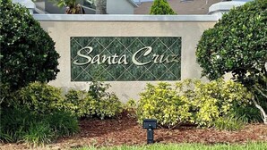A sign for Santa Cruz with a landscaped garden in front.