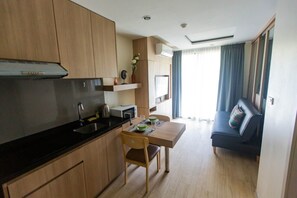 One Bedroom Apartment | Living area | 40-inch flat-screen TV with cable channels, TV - The Chezz Condominium by Patsamon (Pattaya)