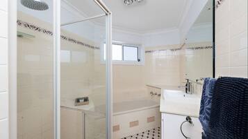 Bathtub, towels, soap, toilet paper