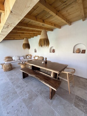A rustic interior with a wooden table, benches, and hanging light fixtures. - Air-conditioned house near Cassis (CARNOUX EN PROVENCE)