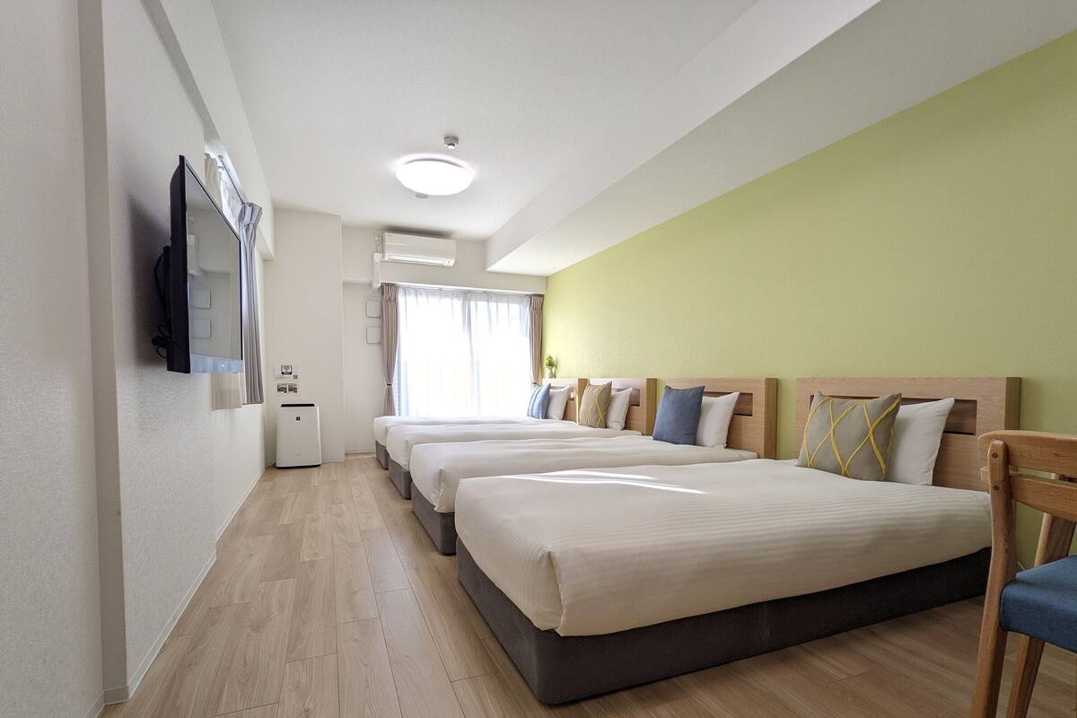 Deluxe Quadruple Room, Multiple Beds, Non Smoking, City View | Premium bedding, blackout drapes, iron/ironing board (on request)