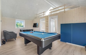 Enjoy a game of pool or relax in the spacious room with a flat-screen TV and comfortable seating.