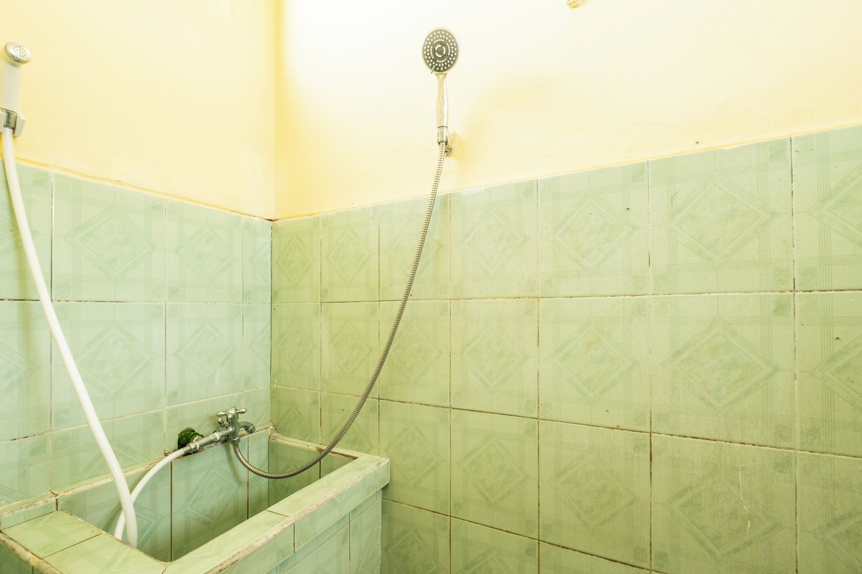 A bathroom with a shower, a sink, and a toilet.