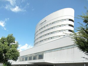 Hotel International features a distinctive curved facade with horizontal bands and large windows.