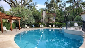 A swimming pool with a no diving sign, surrounded by lounge chairs and a wooden pergola. - St Simons Island,  2 bedroom, 2 bath condo, short walk to village and beaches. (St. Simons)