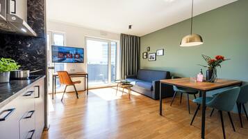 A modern living space with a kitchen, dining area, and seating area.