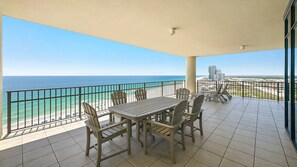 A balcony with a view of the ocean, a table, and chairs. - Wow!! New Owner and New to Rental Market! (Orange Beach)
