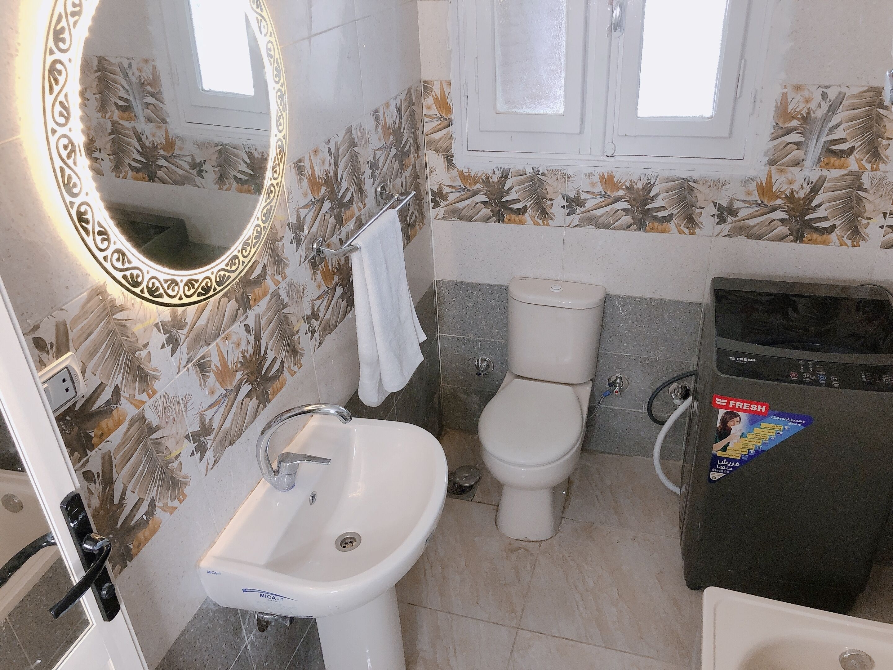 A bathroom with a white sink, a toilet, and a shower area.