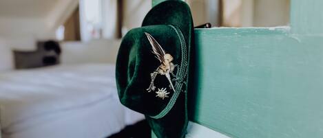 A green wall with a hat hanging on it.