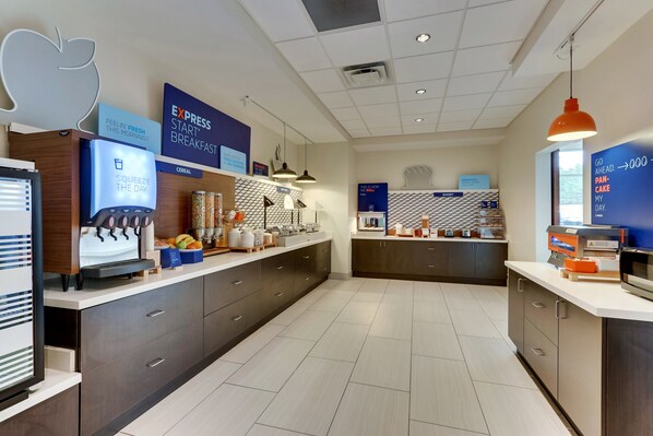 A modern breakfast area with a self-serve station, a cereal dispenser, and a bakery section.