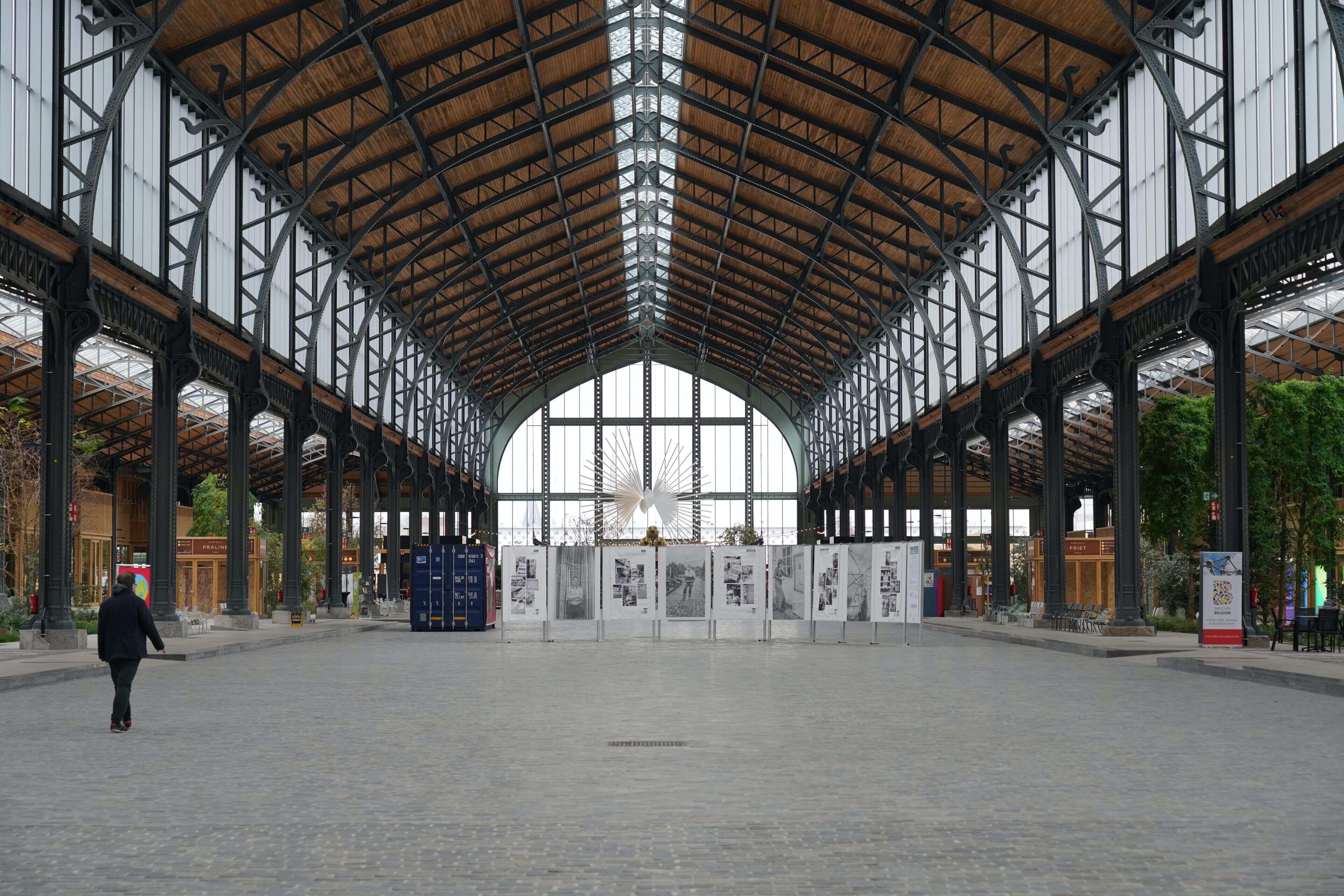 A spacious indoor area with a high, arched ceiling and large windows.