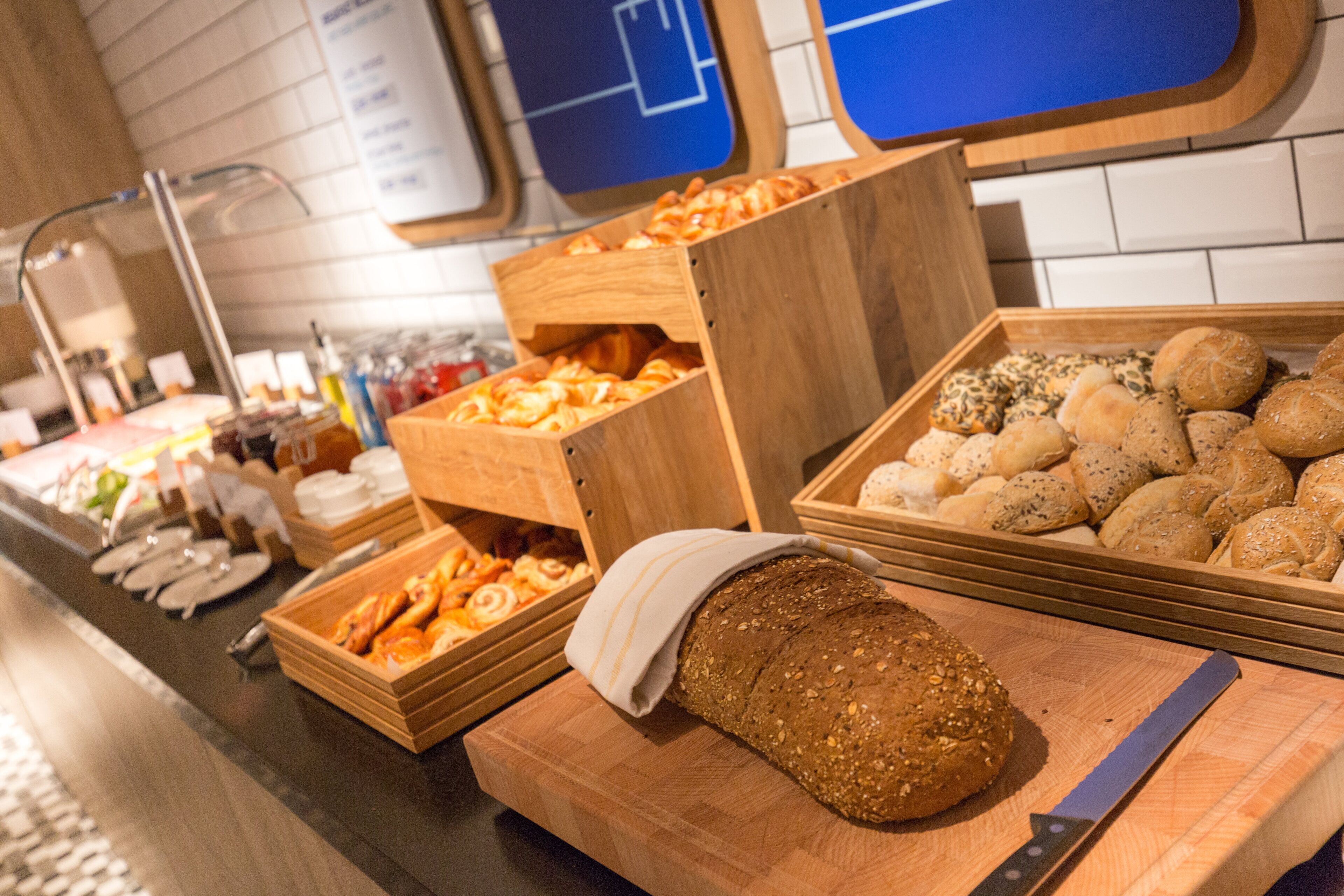 A buffet with various breads and pastries.