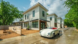 A two-story house with a white exterior and a driveway. -  THE JACK 3 (Waco)