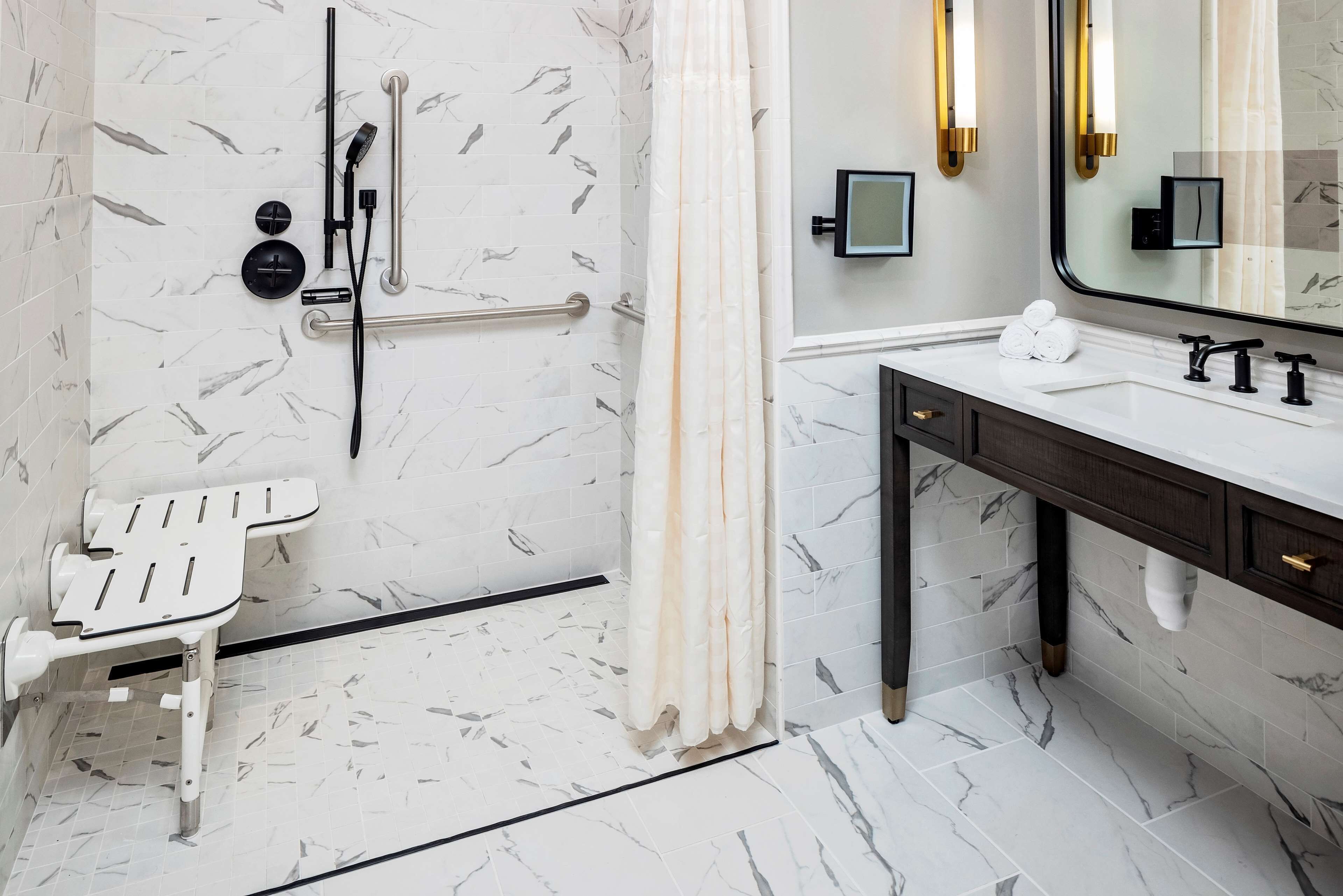 A modern bathroom with a shower, a toilet, and a sink.