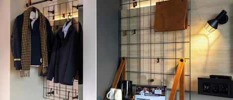 A room with a grid wall, a mounted leather bag, a lamp, and a laptop displaying a game.