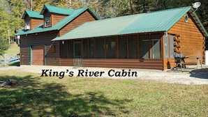 A log cabin with a green roof, a front door, and a bench outside. - King's River Cabin-River Frontage - Fire Pit - Screened Porch (Bryson City)