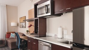 A compact kitchen with a microwave, dishwasher, and refrigerator. - TownePlace Suites Columbia West/Lexington (West Columbia)