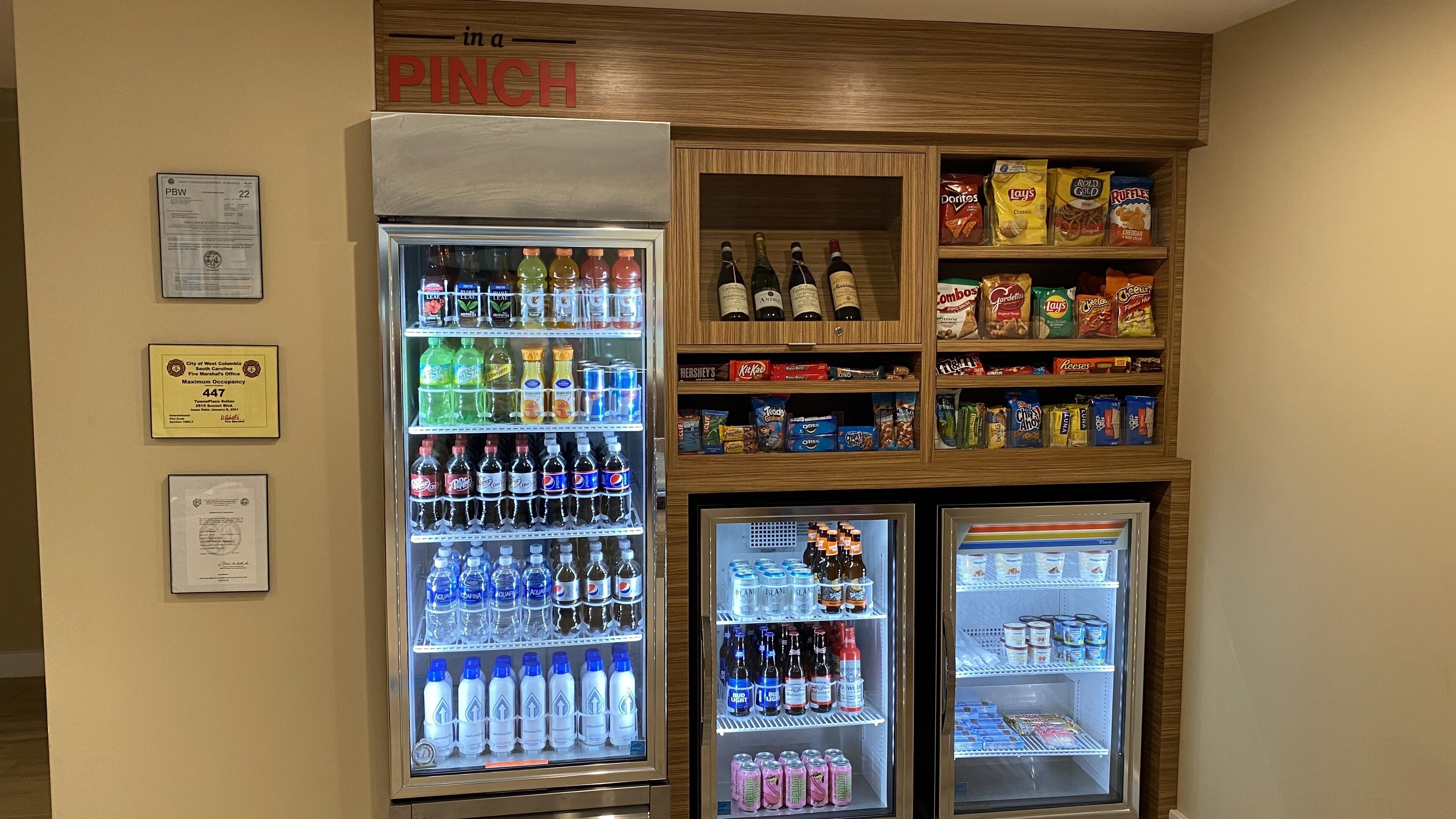A vending machine with various beverages and snacks, including sodas, water, and chips.