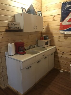 Fridge, microwave, coffee/tea maker, cookware/dishes/utensils