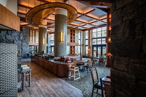Relax in our spacious lobby with a high ceiling, central bar, and comfortable seating areas.