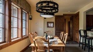 A dining room with a wooden table, chairs, and a chandelier. - Outpost: Grand View 3140 - Air conditioning! (Jackson)