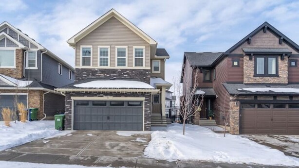 A residential area with houses featuring gabled roofs and garage doors. - Cove On A Hill - Entire (2Bdrm & Full Bath) Basement Suite (Calgary)