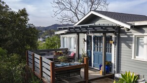 A house with a covered patio, outdoor seating, and potted plants. - Peaceful Hillside Garden Cottage (Los Angeles)