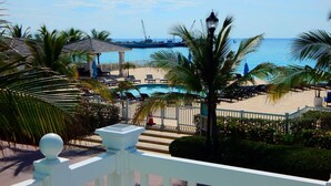 A pool area with lounge chairs and a view of the ocean. - "Infinity Poolside" - Ocean Villa 2 BR / 3 BA  (Bimini)